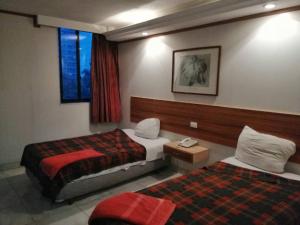 A bed or beds in a room at Hotel El Conde