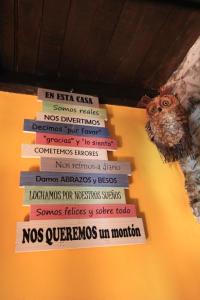 a stack of books with an owl on top at El Perlindango in Villademar