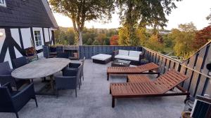 a patio with benches and a table and chairs at Parklife Apartments in Winterberg