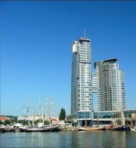 un groupe de grands bâtiments avec des bateaux dans l'eau dans l'établissement Apartament Sea Towers View, à Gdynia
