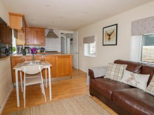 a living room with a couch and a table at Thirley Beck Lodge in Scarborough