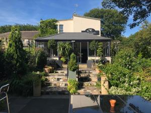 a house with a lot of plants in front of it at Michelangelos - Rooms, Restaurant & Bar in Gateshead