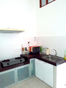 a kitchen with a sink and a stove at Happy Sweet Residence in Melaka