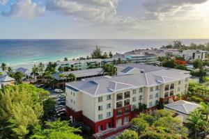 an aerial view of a building with the ocean in the background at Courtyard by Marriott Bridgetown, Barbados in Bridgetown