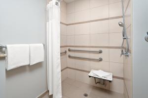 
a bathroom with a shower stall and a toilet at Courtyard by Marriott Bridgetown, Barbados in Bridgetown
