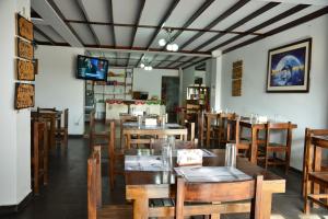 a dining room with wooden tables and chairs at Qallwa Asia in Asia