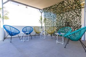 a group of chairs and tables on a patio at New Click & Room in Torremolinos