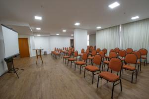 a conference room with chairs and a whiteboard in it at Mondrian Suite Hotel in São José dos Campos +115 photos