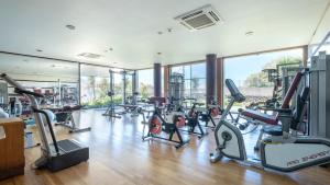 a gym with several treadmills and elliptical machines at Acorsonho Apartamentos Turisticos in Capelas