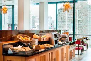 a buffet line with bread and baskets of food at Park Inn by Radisson Aberdeen in Aberdeen