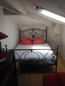 a bedroom with a black bed with red pillows at Crew Lighthouse in Antibes