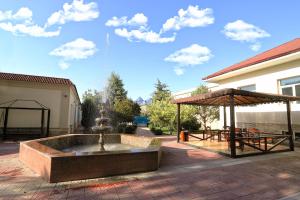 a fountain in the middle of a patio at VIARDO Hotel in Tashkent