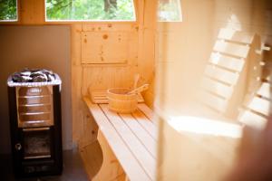 a small cabin with a bench and a window at Hotel Posta in Forni di Sopra