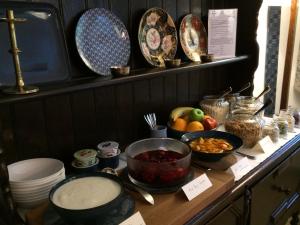 a counter with bowls and plates of food on it at Low Raisgill B&B in Buckden