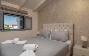 a bedroom with a large bed and a window at Villa Shameti - Private Villa with Pool and Billiards Near Zakynthos Town By Villa Mana Gers in Zakynthos Town