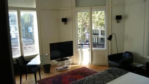 - une chambre avec un lit, une télévision et une table dans l'établissement Au Cœur De Lille, à Lille