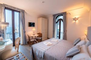 a hotel room with a bed and a balcony at Covo dei Saraceni in Polignano a Mare