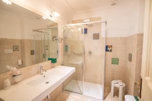 a bathroom with a shower and a sink and a toilet at Covo dei Saraceni in Polignano a Mare