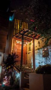 a house with a wooden door with lights on it at Pup Hostel SC in Florianópolis