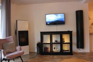 a living room with a television on a wall at Wohnen am Solbad in Bad Salzungen