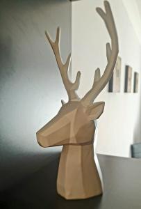 a wooden reindeer statue sitting on a table at 168 - ExcellentStays - 2 Bedroom Flat in Stanwell