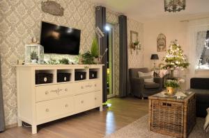 a living room with a tv on a white dresser at Ferienwohnung Nitsche in Bad Laasphe