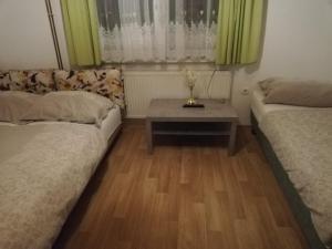 Habitación pequeña con 2 camas y mesa. en Apartmaji Pri Kokolu, en Bled