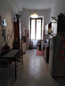a kitchen with a table and a refrigerator at Trastevere Corner Eight in Rome