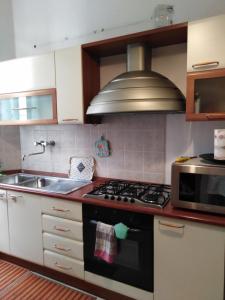 a kitchen with a stove and a sink at Trastevere Corner Eight in Rome
