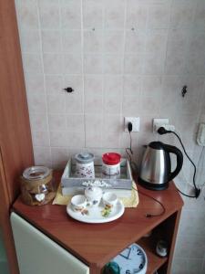 a table with a tea pot and cups on it at Trastevere Corner Eight in Rome