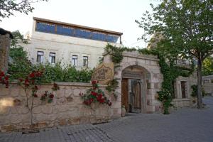 a building with a sign on the side of it at Safran Cave Hotel in Goreme