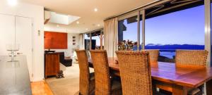 a dining room with a table and chairs with a view at Penthouse 39 in Nelson
