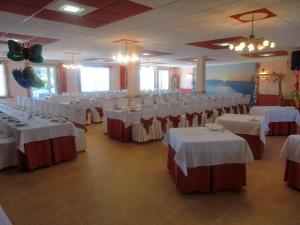 a banquet hall with white tables and chairs at O Lar da Avoa in Cambados +28 photos