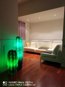 a living room with a couch and green lights at casa dolce casa in Modena