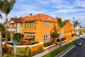 an orange house on a street with palm trees at 8A Peaceful oasis in Huntington Beach