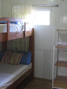 a room with two bunk beds and a window at Cosy home for short stay or a weekend getaway in Paramaribo