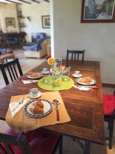 drewniany stół z talerzami żywności w obiekcie Casa del artista w Aronie