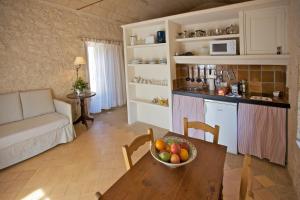 a living room with a bowl of fruit on a table at Finca Son Josep de Baix in Calas de Mallorca