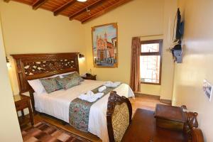 a bedroom with a large bed and a window at Hotel La Basílica Quito in Quito +74 photos