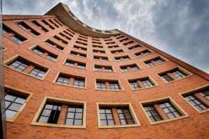 a tall brick building with many windows on it at Hotel Dann Carlton Cali in Cali