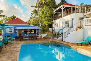 a villa with a swimming pool and a house at Sugar Apple Bed and Breakfast in Christiansted