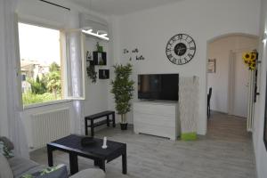 a living room with a tv and a couch and a table at Pisa Apartment Tower in Pisa