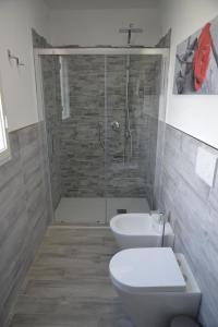 a bathroom with a shower and a toilet and a sink at Pisa Apartment Tower in Pisa