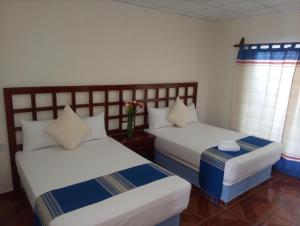 Postel nebo postele na pokoji v ubytování Hotel D Abril