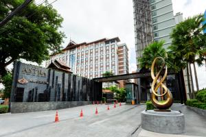 a sculpture in front of a building with orange cones at Anta Residence ''Self-sevice apartment'' in Chiang Mai