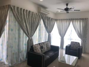 a living room with a couch and a window at The Loft Imago in Kota Kinabalu