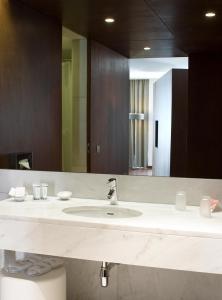 a bathroom with a sink and a large mirror at Pousada Palacio de Estoi – Small Luxury Hotels of the World in Estói