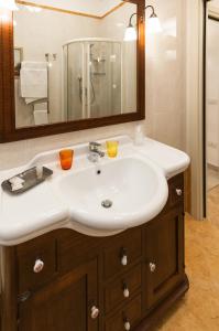 a bathroom with a white sink and a mirror at IL VICOLETTO Appartamento in Cesena