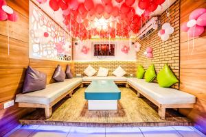 a room with couches and a table and balloons at FabHotel Imperio - Nr Baner Hill in Pune
