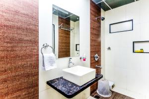 a bathroom with a sink and a mirror at FabHotel Imperio Baner in Pune